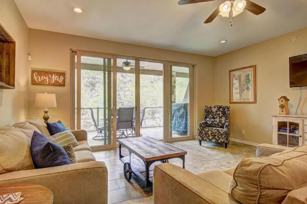 a living room with a couch and a table at RG 208 Rivendell On The Guadalupe in Canyon Lake
