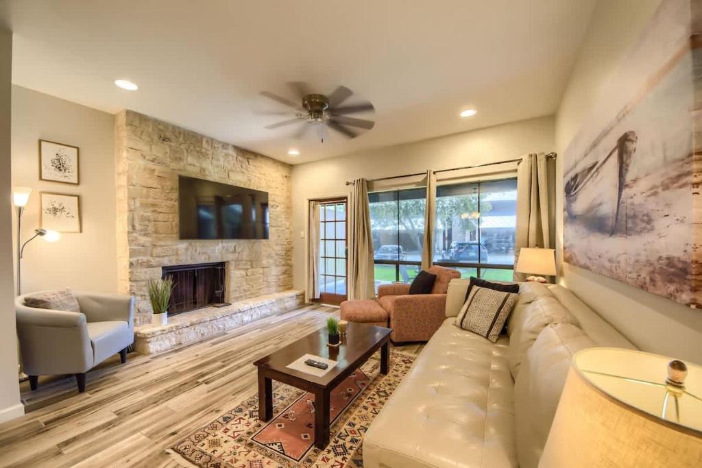 a living room with a couch and a fireplace at CW C101 Condo de Comal in New Braunfels