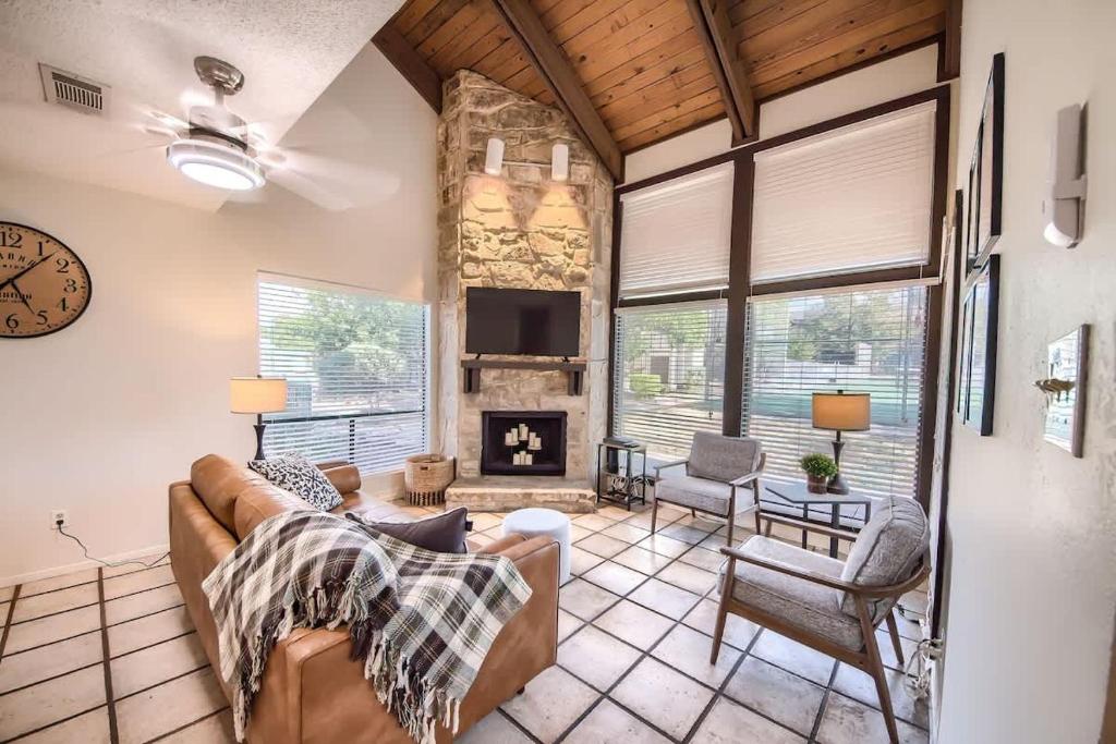 a living room with a couch and a fireplace at TBM 112 Among The Oaks in New Braunfels