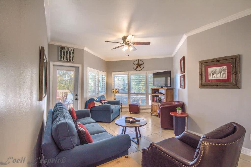a living room with a blue couch and chairs at IC 112 Cowboy Corral in New Braunfels