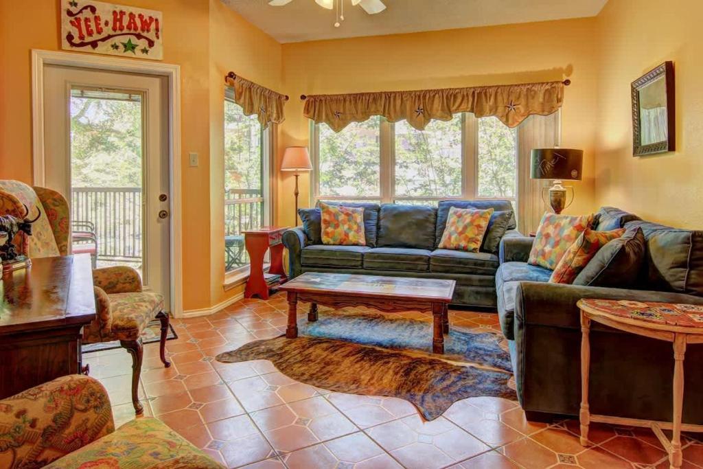 a living room with a couch and a table at IC 110 Comal Corral in New Braunfels