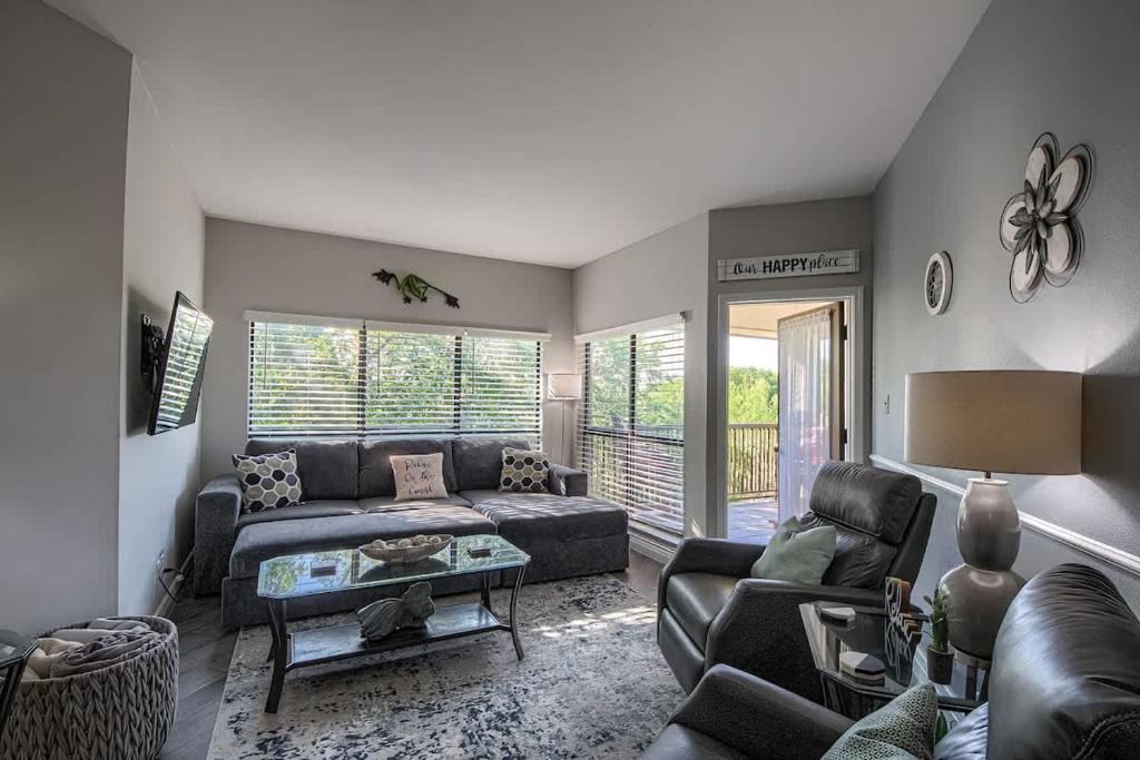 a living room with a couch and a table at IC 316 Riverfront Bliss in New Braunfels