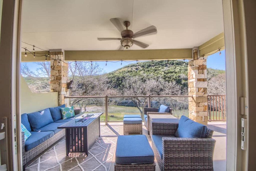 a porch with a couch and chairs and a ceiling fan at RG 306 Hillside River Retreat in Canyon Lake