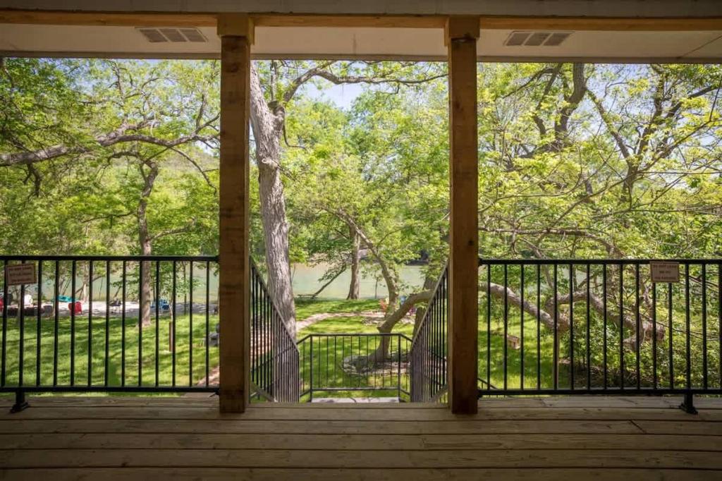 a screened porch with a view of a park at RR 1300 Hondos River Haus in Canyon Lake