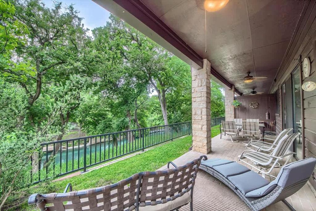 a porch with chairs and a table and a fence at CW C113 Comal Vista in New Braunfels