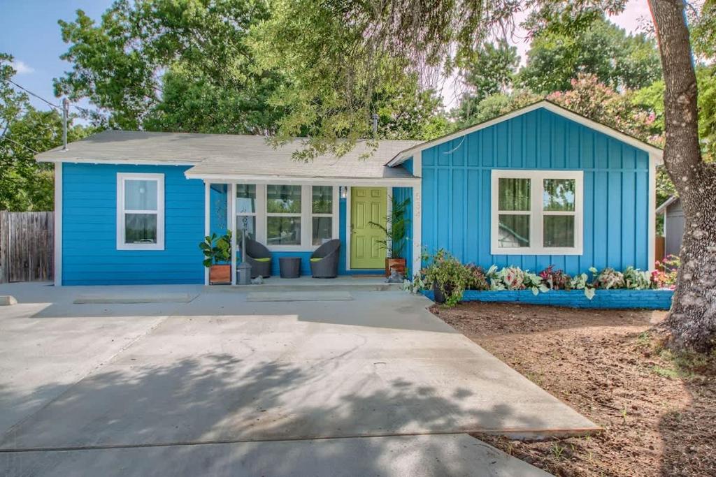 a blue tiny house with a porch at DT 534 Castle Shadow Cottage in New Braunfels