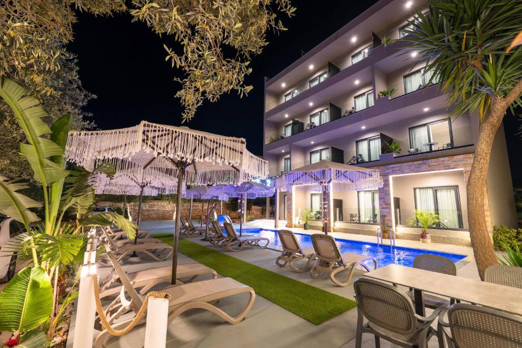 a hotel with a swimming pool at night at Hotel Resol 2 in Ksamil