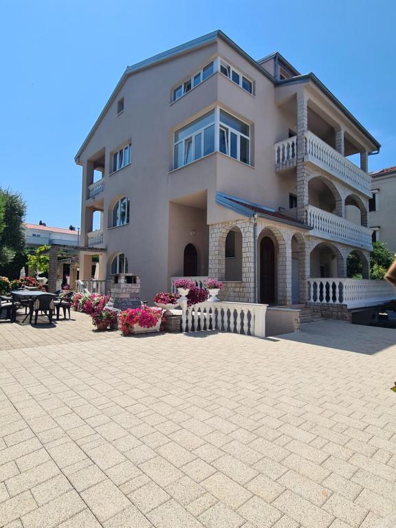 a large building with a patio in front of it at Villa Rea in Malinska