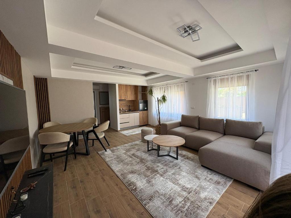 a living room with a couch and a table at Divine Apartmani in Dobanovci
