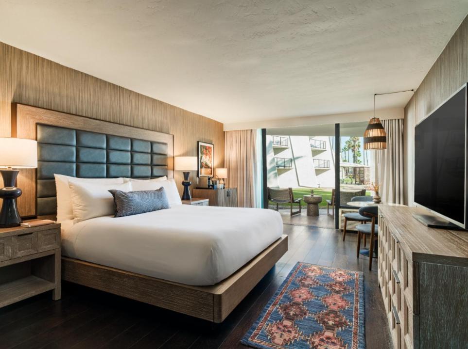 a bedroom with a large bed and a television at The Maya in Long Beach