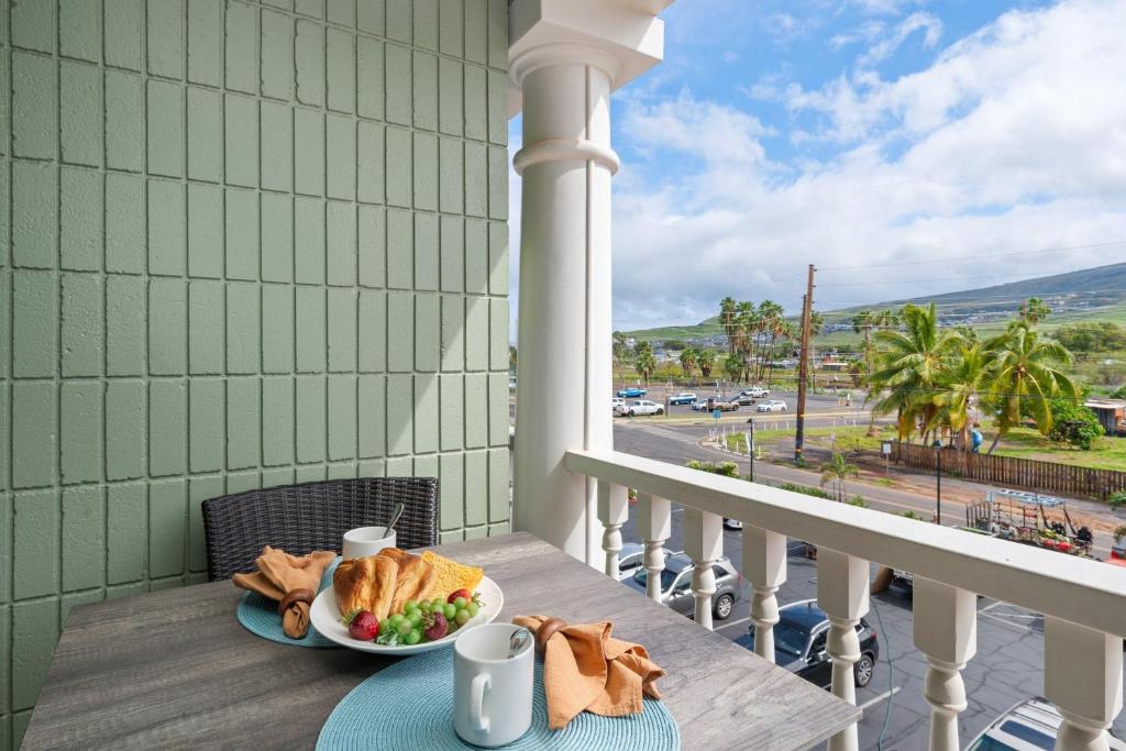 a table with a plate of food on a balcony at Lahaina Shores 320 in Lahaina