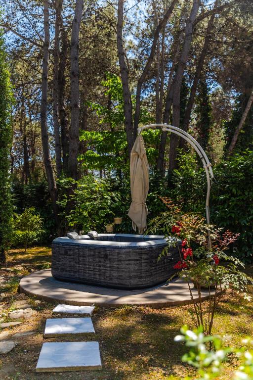 a fountain in the middle of a garden at The Garden Jacuzzi Apartment By PS in Golem