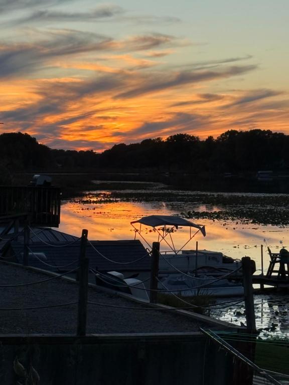 a boat docked at a marina at sunset at Dragonfly Cottage in Plymouth
