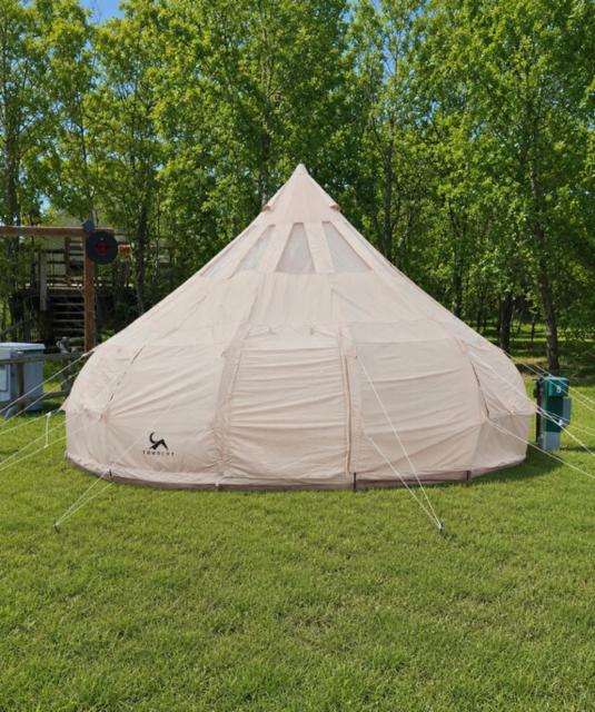 a tent sitting in the grass in a field at Prairie Junction Glamping Tent in Stettler
