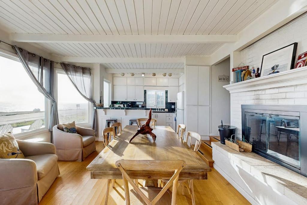 a living room with a table and a fireplace at Sunset Escape in Bodega Bay