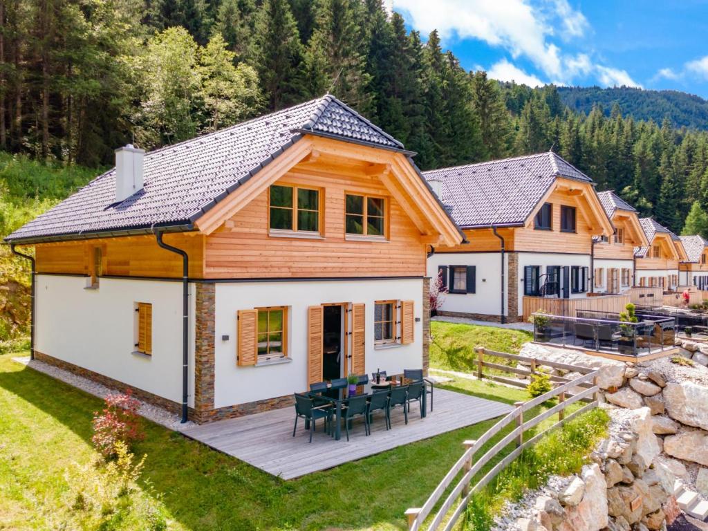 an image of a log home with a deck at Haus am Wald in Donnersbachwald