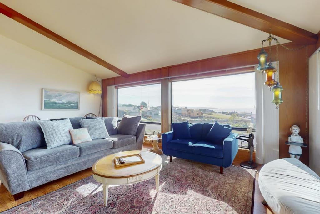 a living room with a couch and a table at Pinnacle Heights in Bodega Bay