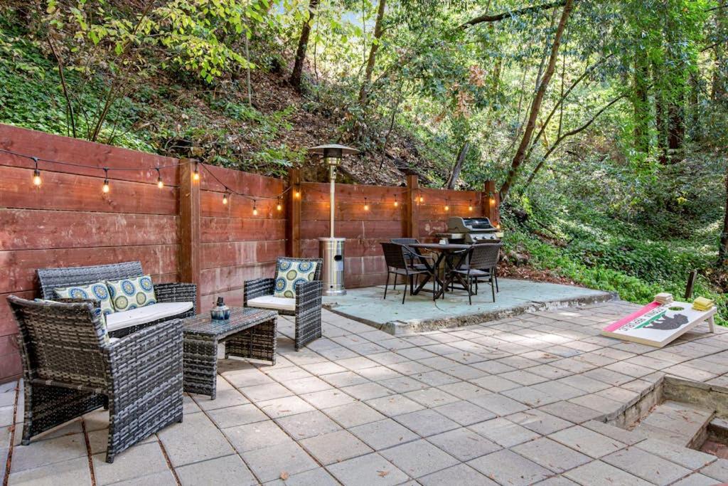 a patio with a table and chairs and a grill at Canyon House in Guerneville