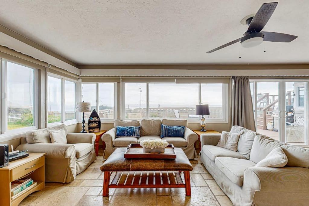 a living room with couches and a ceiling fan at Cozy Carmet Cottage in Bodega Bay