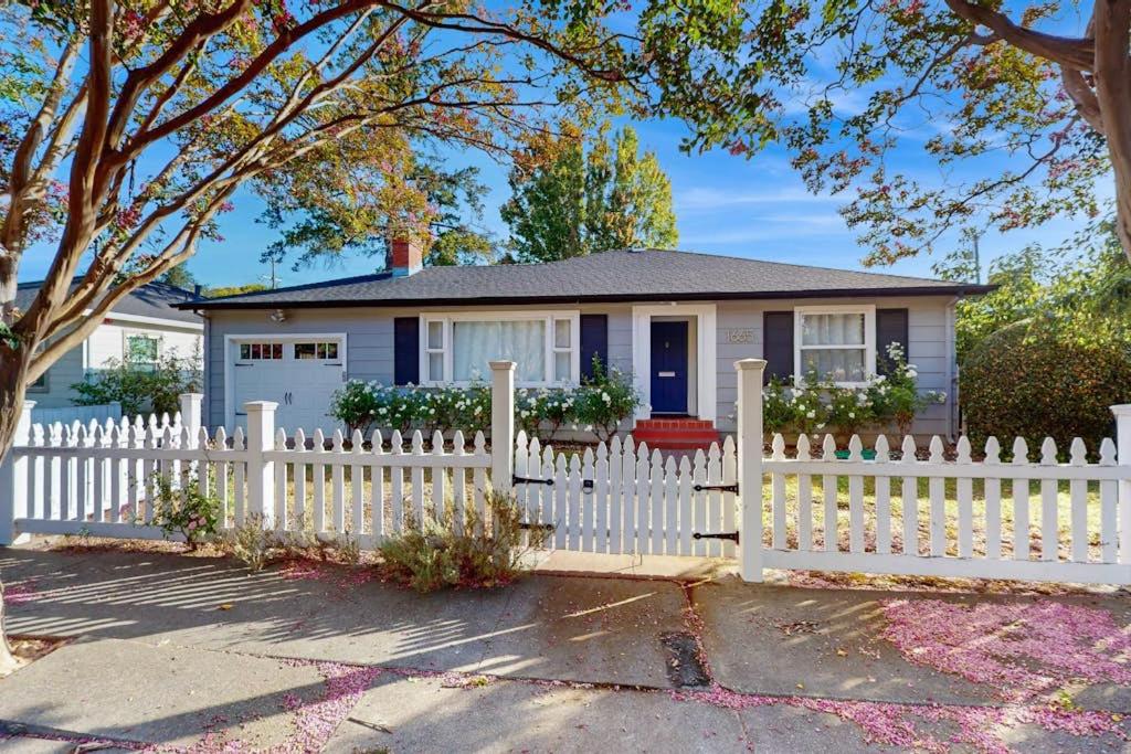 a white picket fence in front of a house at James House in Santa Rosa