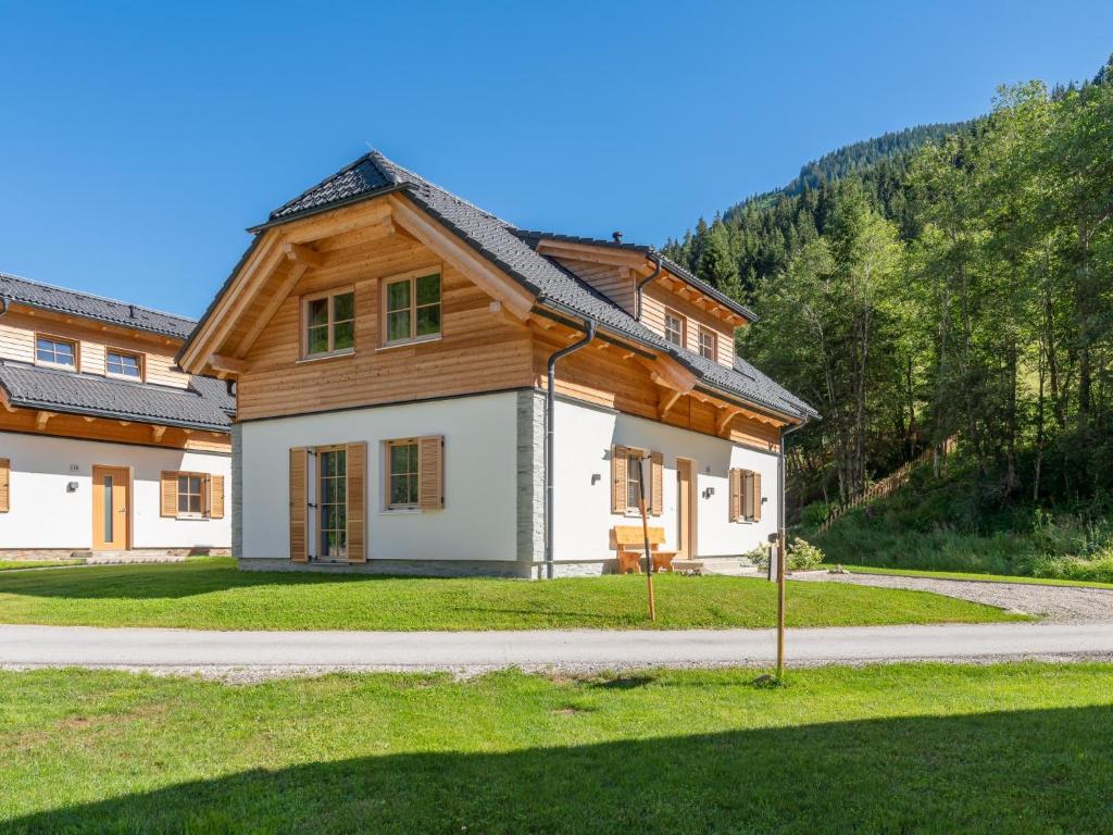 a house with a wooden roof on a road at Villa Petra in Donnersbachwald