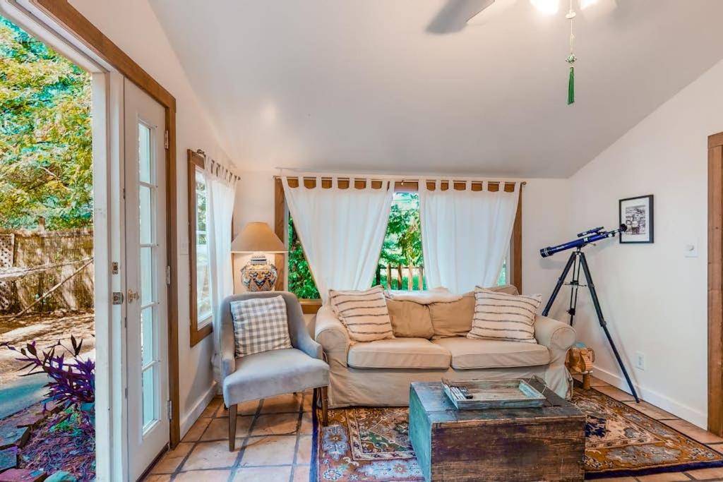 a living room with a couch and a chair at Vineyard Cottage in Guerneville