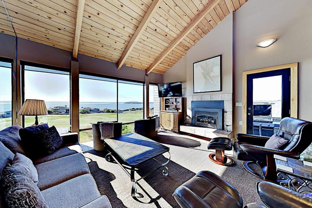 a living room with a couch and chairs and a fireplace at Fairview Grande in Bodega Bay