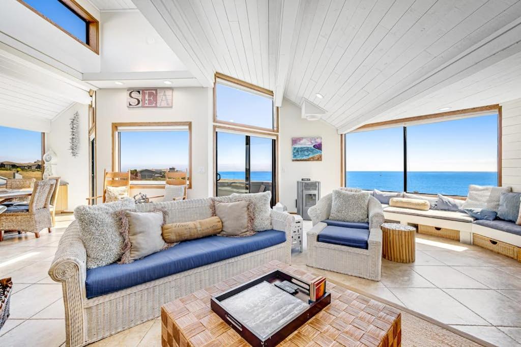 a living room with a blue couch and a table at Blue Horizon in Bodega Bay
