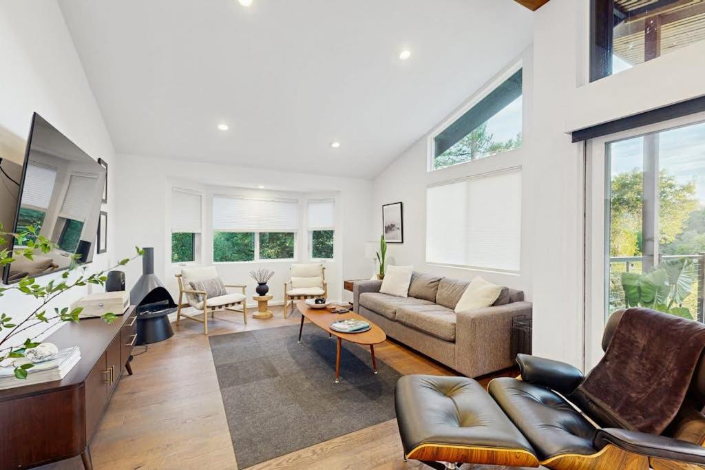 a living room with a couch and a table at Rio Lindo River Retreat in Healdsburg