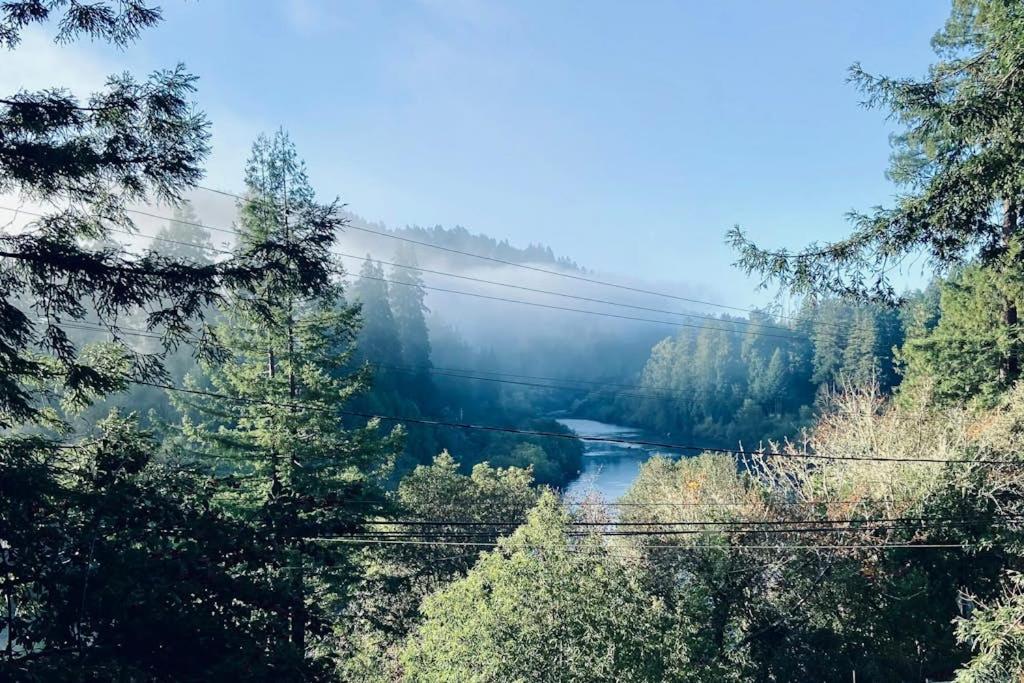 a bridge over a river in the middle of a forest at Monte Rio Vista Lodge in Monte Rio
