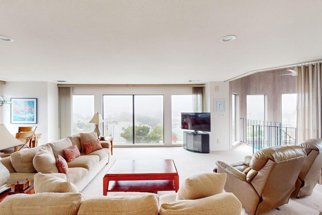 a living room with couches and a tv at Sea Way Dreams in Bodega Bay