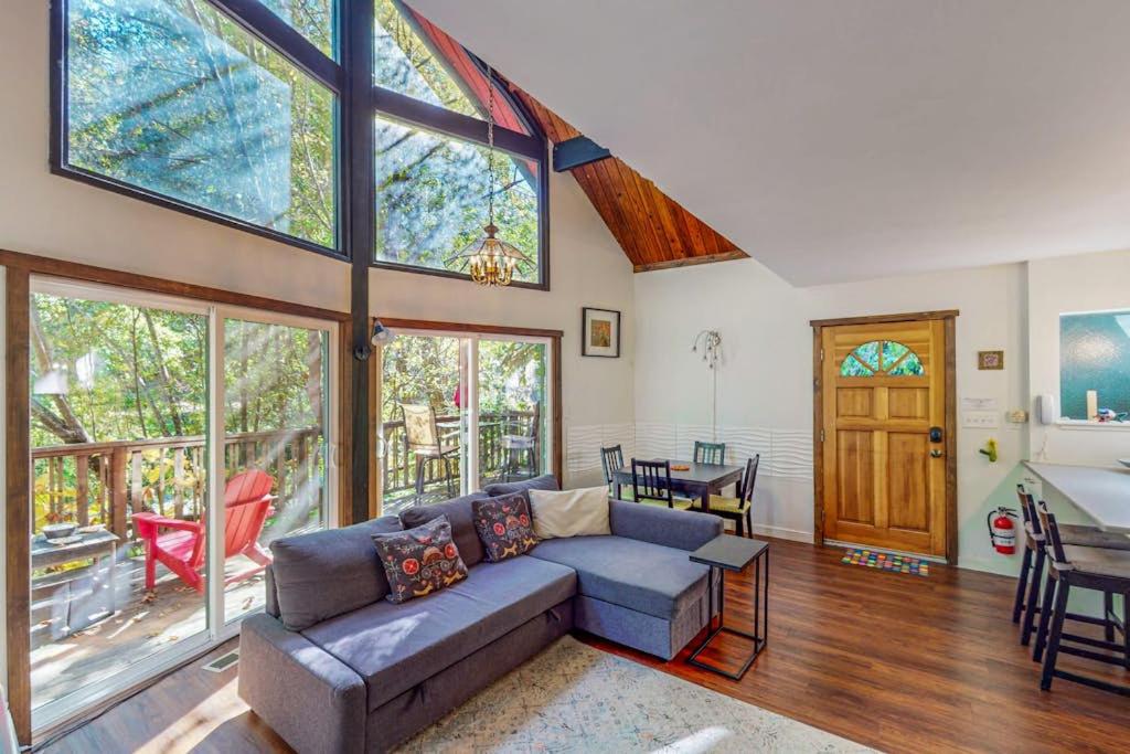 a living room with a couch and a large window at Cazadero Dreams in Cazadero