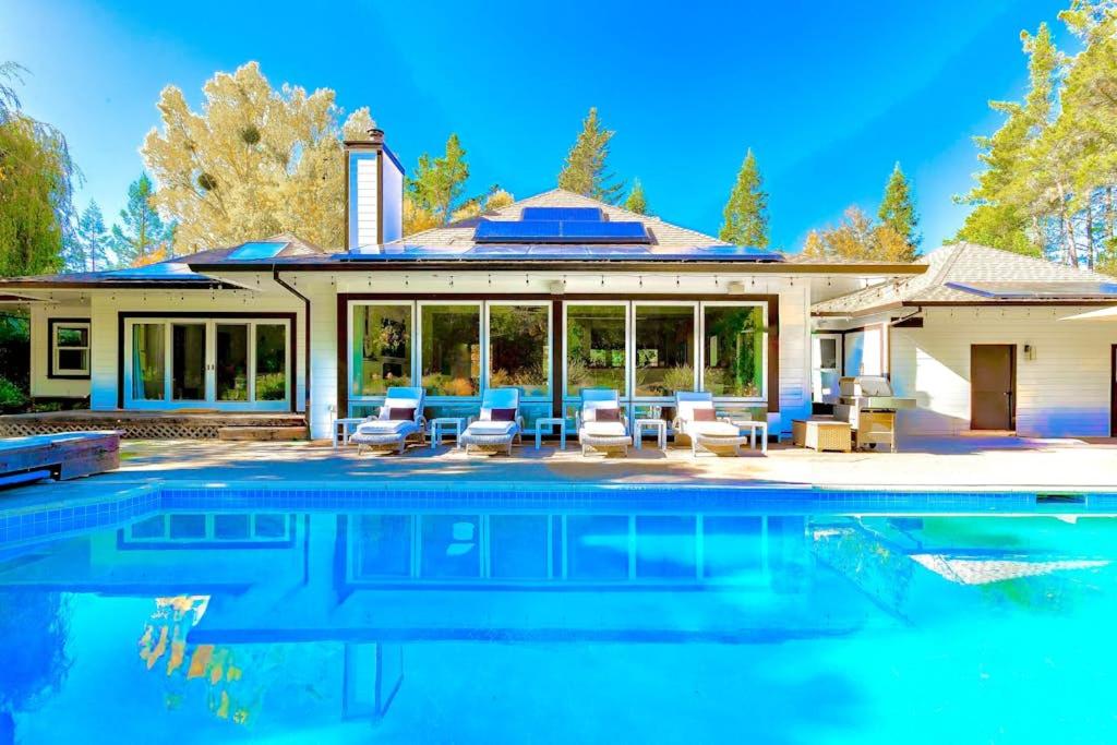 a house with a swimming pool in front of a house at Zegarra Estate in Sebastopol