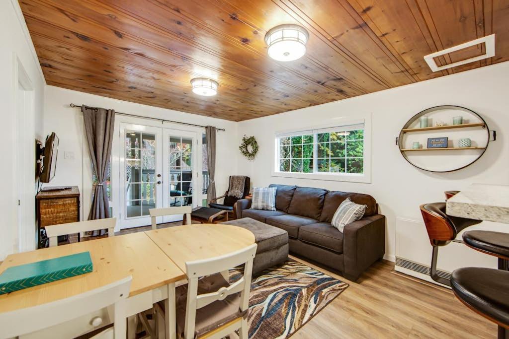 a living room with a couch and a table at Wanderlust Cottage in Guerneville