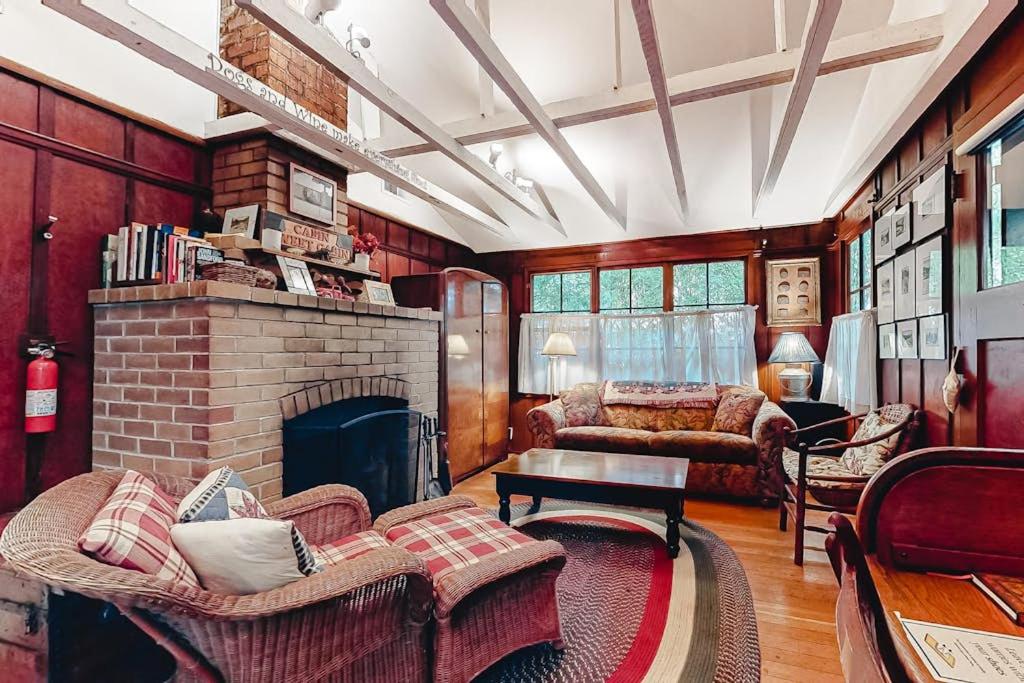 a living room with a brick fireplace and a couch at Clearheart Grove in Guerneville