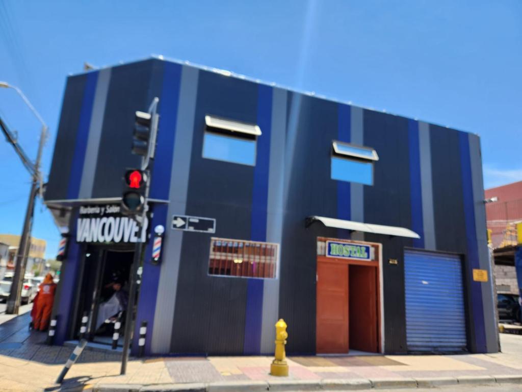 a blue building on the corner of a street at Hostal Tamarhugo in Calama