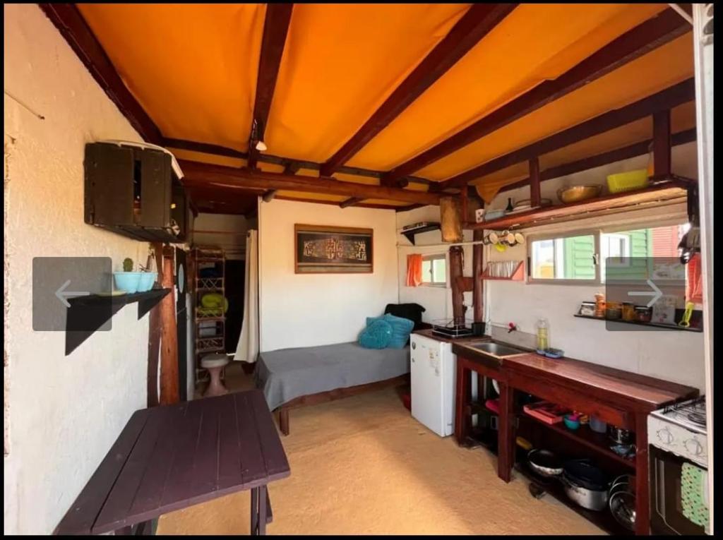 a kitchen and living room with a bed in a room at Casa Sur in Cabo Polonio