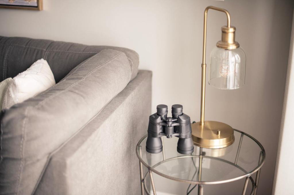 a glass end table with a lamp next to a couch at Newly Renovated Condo in Harborside! in South Haven