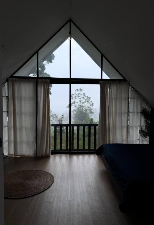 an empty room with a large window and a wooden floor at Margaritas House in Buenos Aires