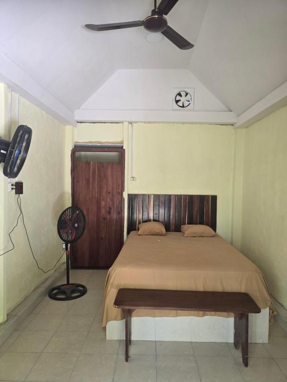 a bedroom with a bed and a ceiling fan at Cabanas chaac Calakmul in Xpujil