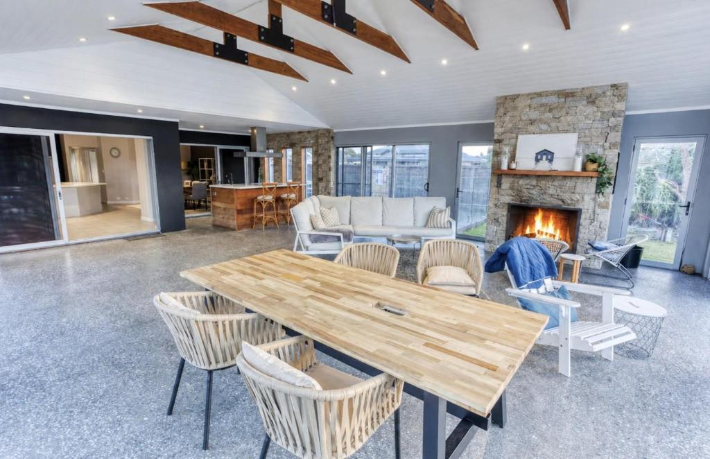 a living room with a table and a fireplace at Aqua Tides - Port Geographe in Geographe