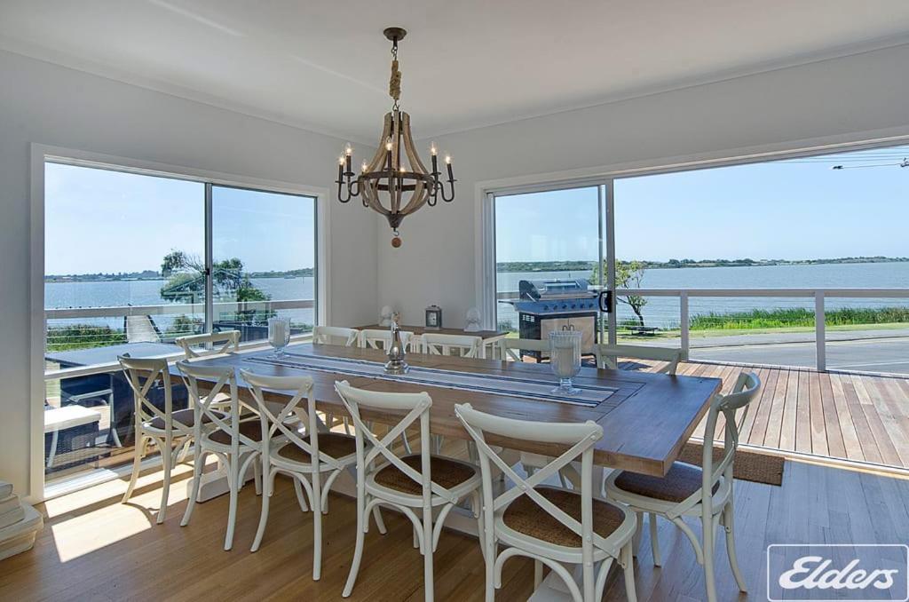 a dining room with a large table and chairs at Riverside Dream - 109 Barrage Rd in Goolwa South