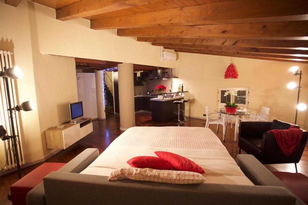 a living room with a large bed and a couch at Casa Vacanze Funicolare in Bergamo