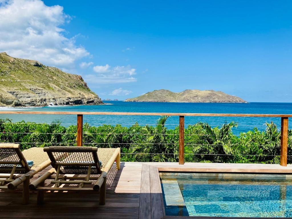 a resort with a swimming pool and a view of the ocean at Case Macalpa in Saint Barthelemy
