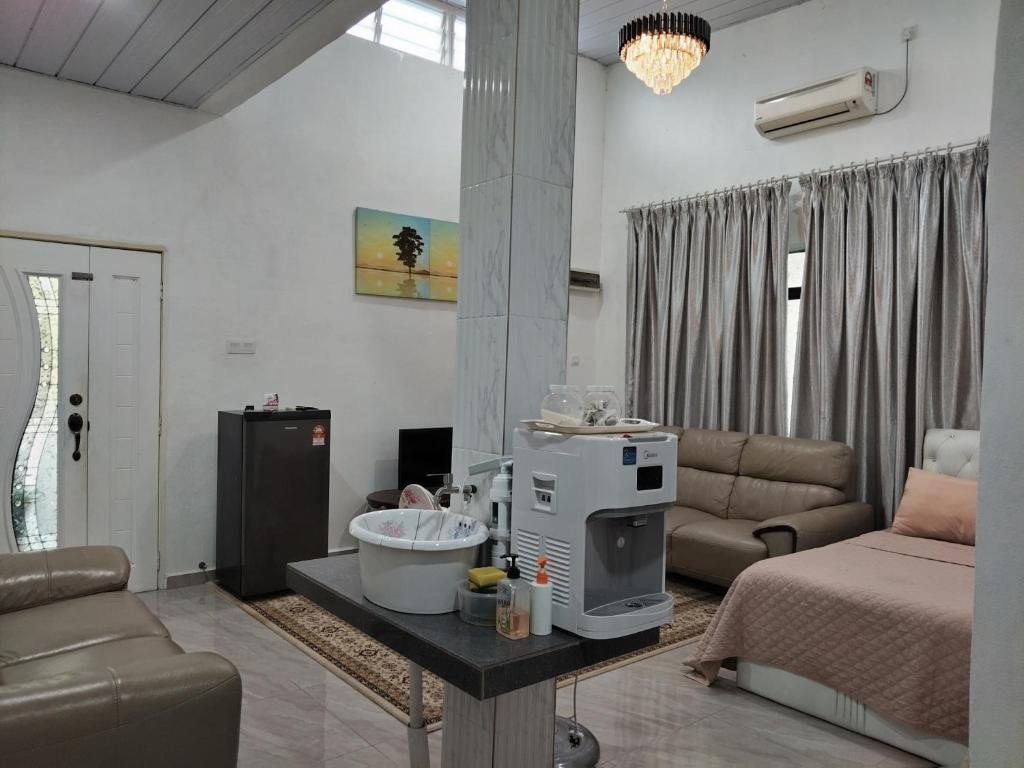 a living room with a room with a bed and a kitchen at Makwan Homestay B in Kubang Semang