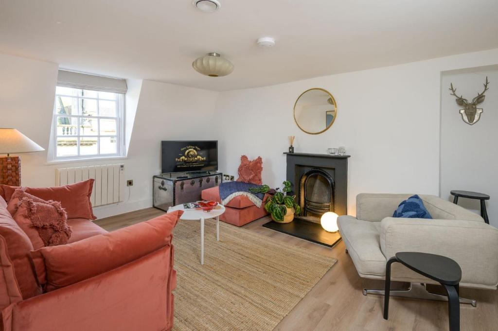 a living room with a couch and a fireplace at Milsom Loft in Bath