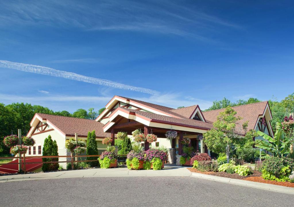 a large house with flowers in front of it at Hilton Grand Vacations Christmas Mountain Village Wisconsin in Wisconsin Dells