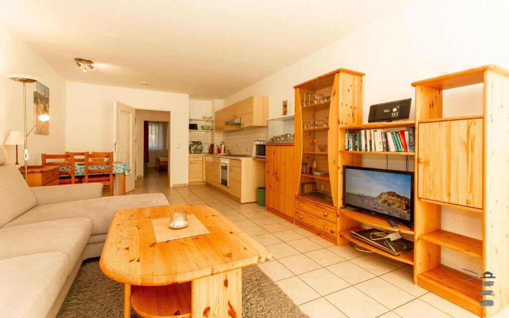a living room with a couch and a table at Wattschnecke in Böhl