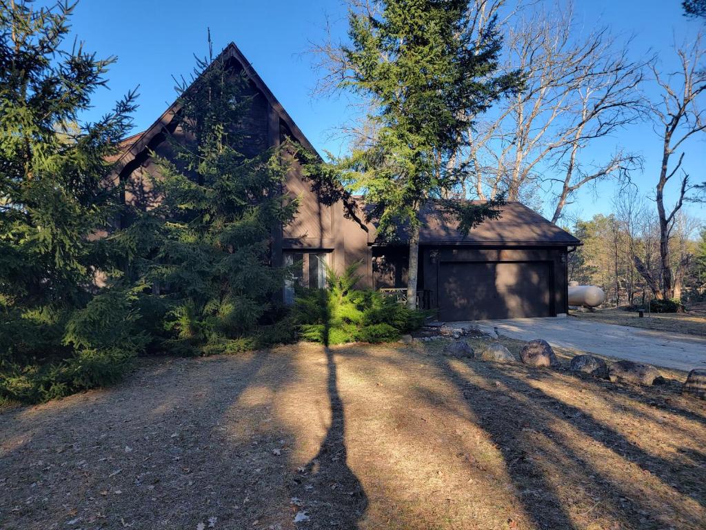 a house with a tree in front of it at Secluded Chalet in Harrison