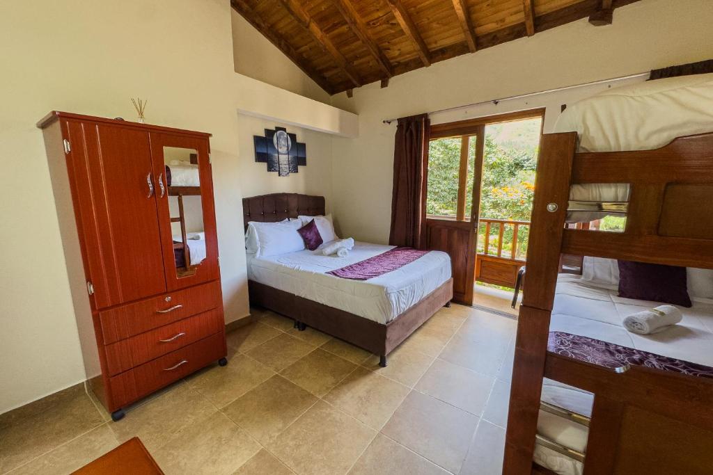 a bedroom with two bunk beds and a window at Apartahotel Balcones de Nariño 2 in Villa de Leyva